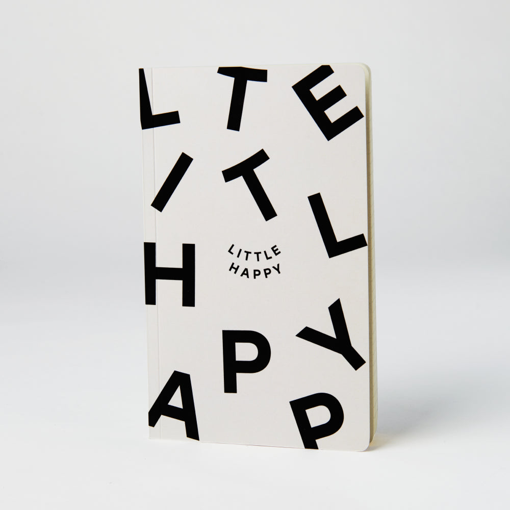 Little Happy notebook with fun type graphic on the cover