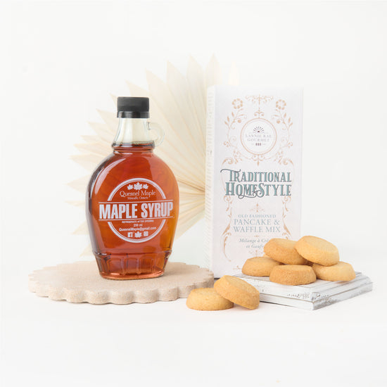 Collection of gift box items with maple syrup and pancake mix